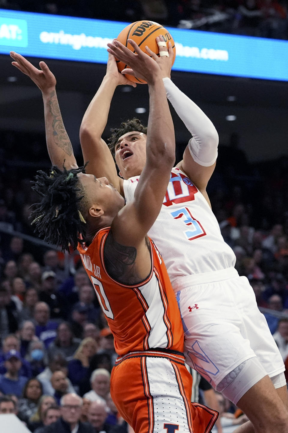 Northwestern guard Ty Berry, right, drives to the basket against Illinois guard Terrence Shannon Jr. during the second half of an NCAA college basketball game in Evanston, Ill., Wednesday, Jan. 24, 2024. (AP Photo/Nam Y. Huh)