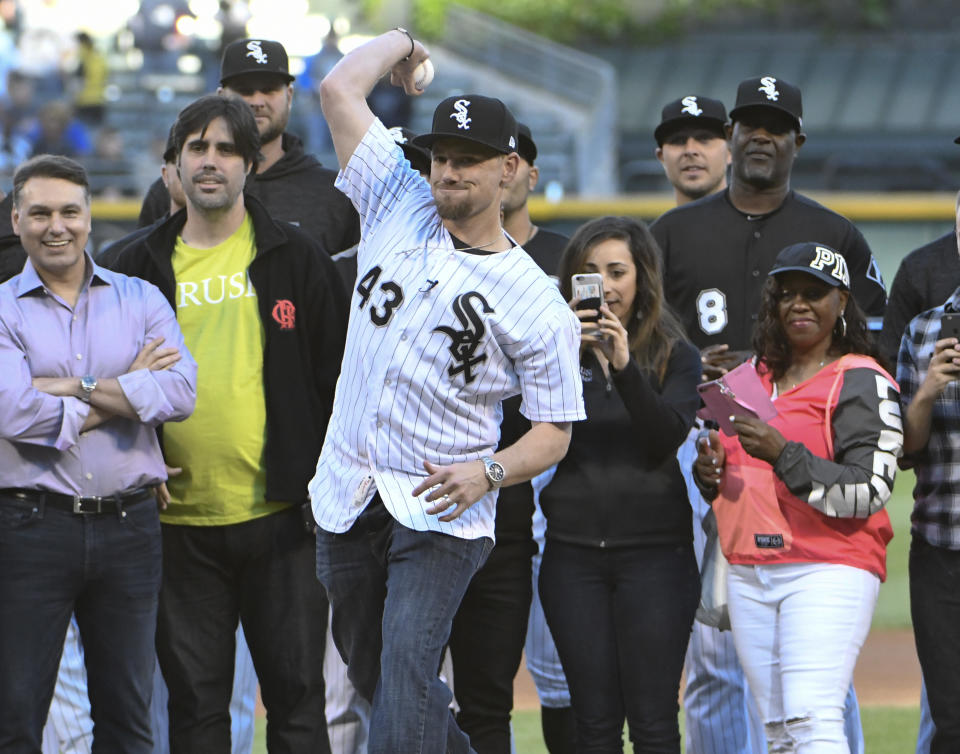 Chicago White Sox pitcher Danny Farquhar (43) throws out a ceremonial first pitch before a baseball game between the White Sox and the Milwaukee Brewers on Friday, June 1, 2018, in Chicago. Farquhar was hospitalized after suffering a ruptured brain aneurysm during a baseball game in April. (AP Photo/David Banks)