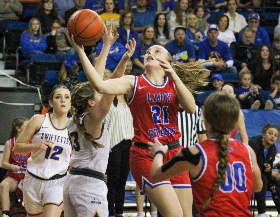 Claude's Alison Stone (21) attempts a shot against Nazareth in the Region I-1A championship girls basketball game in the Texan Dome at Levelland on Saturday, Feb. 25, 2023.