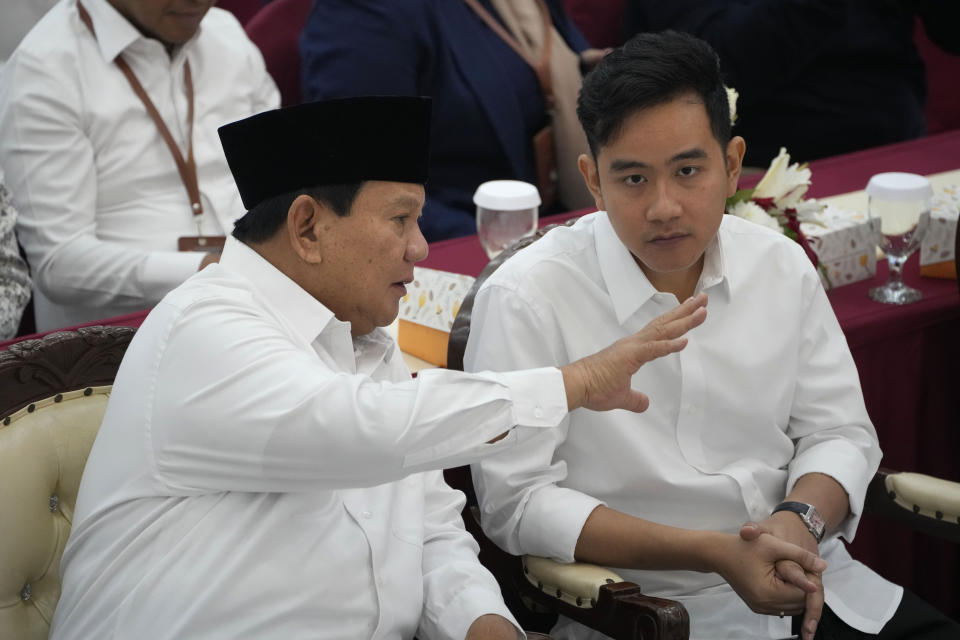 Indonesian Defense Minister and president-elect Prabowo Subianto, left, talks with running mate Gibran Rakabuming Raka, the eldest son of Indonesian President JokoWidodo, during their formal declaration as president and vice president-elect at the General Election Commission building in Jakarta, Indonesia, Wednesday, April 24, 2024. Indonesia’s electoral commission formally declared Subianto as the elected president in a ceremony on Wednesday after the country’s highest court rejected appeals lodged by two losing presidential candidates who are challenging his landslide victory. (AP Photo/Dita Alangkara)
