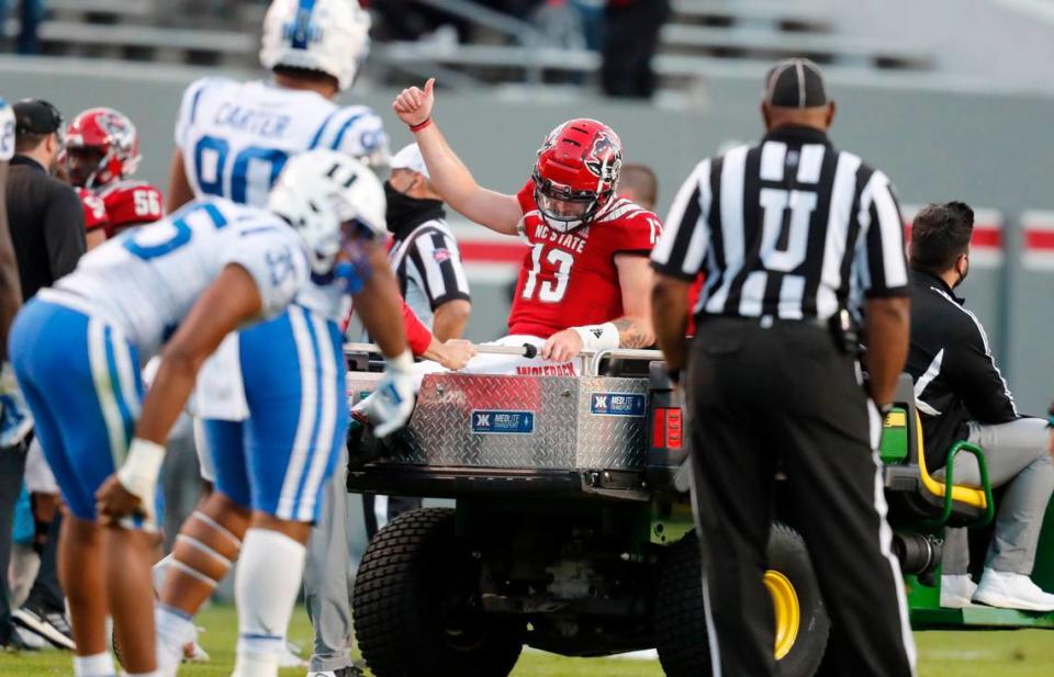 N.C. State quarterback Devin Leary (13) gives a thumbs-up as he is taken off the field after being injured during the second half of N.C. State’s 31-20 victory over Duke at Carter-Finley Stadium in Raleigh, N.C., Saturday, Oct. 17, 2020.