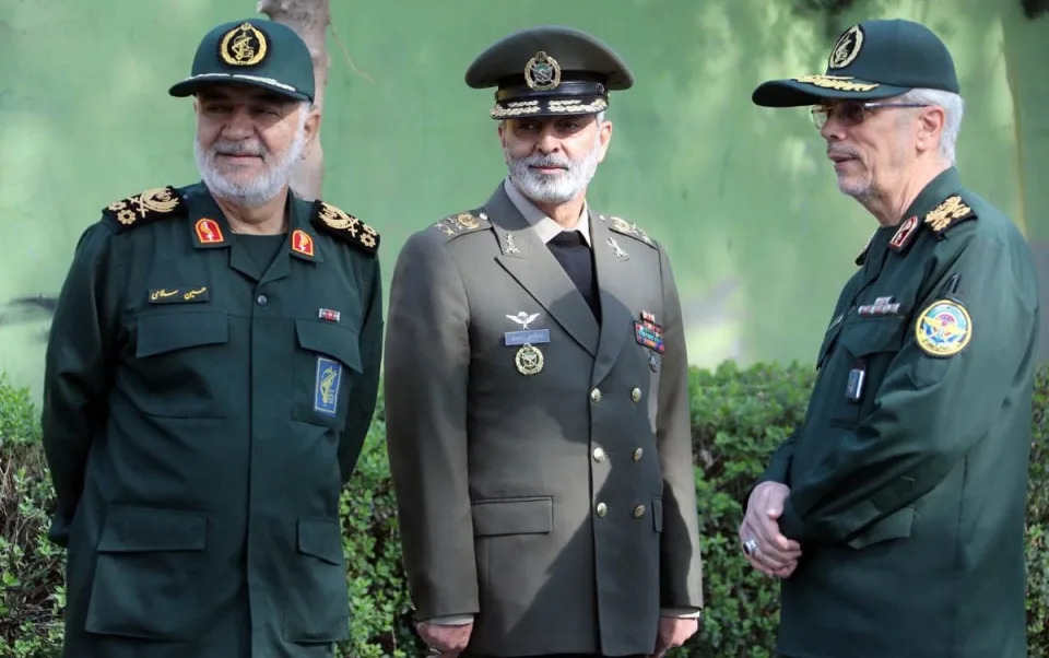 Hossein Salami, the head of the IRGC, Iranian Army Major General Abdolrahim Mousavi, and Major General Mohammad Bagheri, the chief of staff of the Iranian Armed Forces, attend the Army Day parade at a military base in northern Tehran on Wednesday