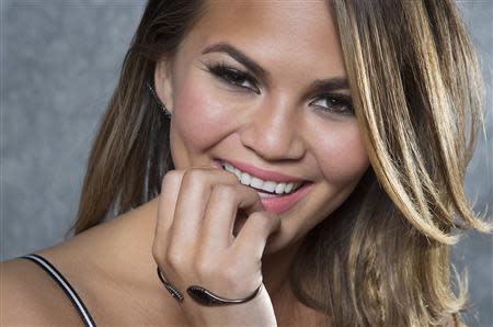 Supermodel and 2014 Sports Illustrated cover model Chrissy Teigen poses for a portrait in New York February 18, 2014. REUTERS/Carlo Allegri