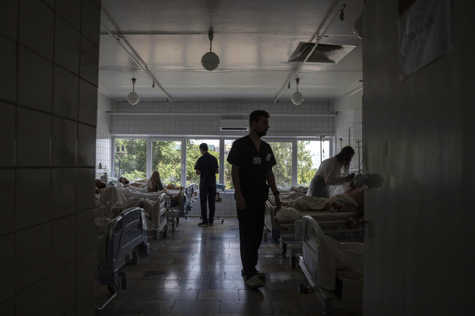 Medics treat Ukrainian soldiers at the ICU of Mechnikov Hospital in Dnipro, Ukraine, Saturday, July 15, 2023. A surge of wounded soldiers has coincided with the major counteroffensive Ukraine launched last month to try to recapture its land from Russian forces. Surgeons at Mechnikov Hospital, one of the country's biggest, are busier now than perhaps at any other time since Russia began its invasion 17 months ago. (AP Photo/Evgeniy Maloletka)