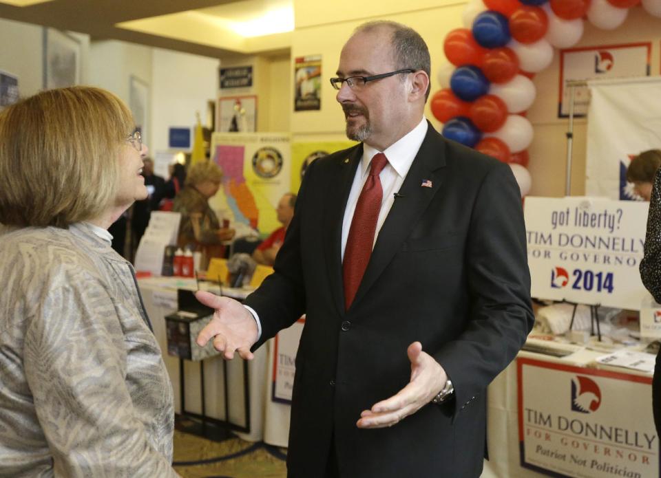 Gubernatorial candidate Tim Donnelly speaks with a supporter at the California Republican Party 2014 Spring Convention in Burlingame, Calif. on Saturday, March 15, 2014. California Republicans are gathering in the San Francisco Bay Area to plan the future of the party in a state where their registration and influence have been sliding. (AP Photo/Ben Margot)