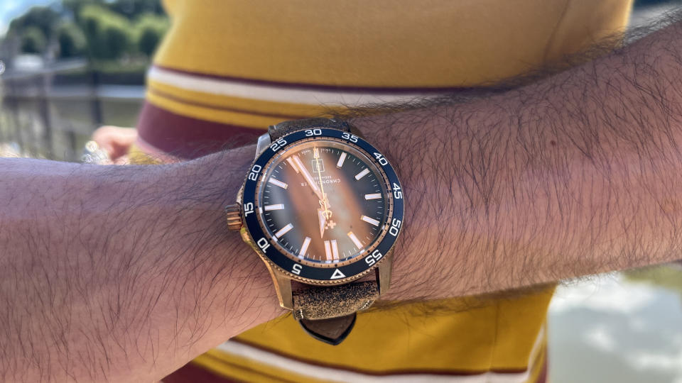 The Christopher Ward C60 Pro 300 Bronze worn near a river