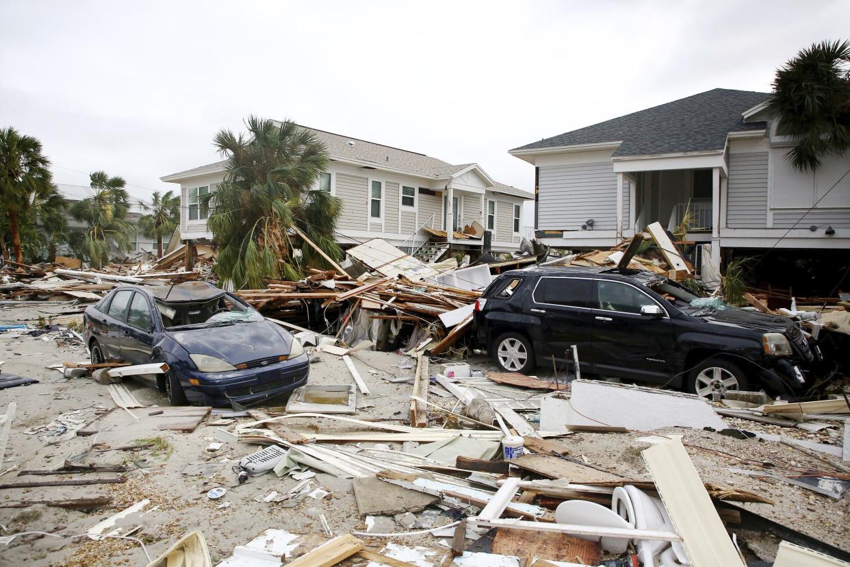 Remnants of damaged homes and flooded vehicles are seen in Fort Myers Beach, Fla., on Thursday, Sep 29, 2022, following Hurricane Ian.