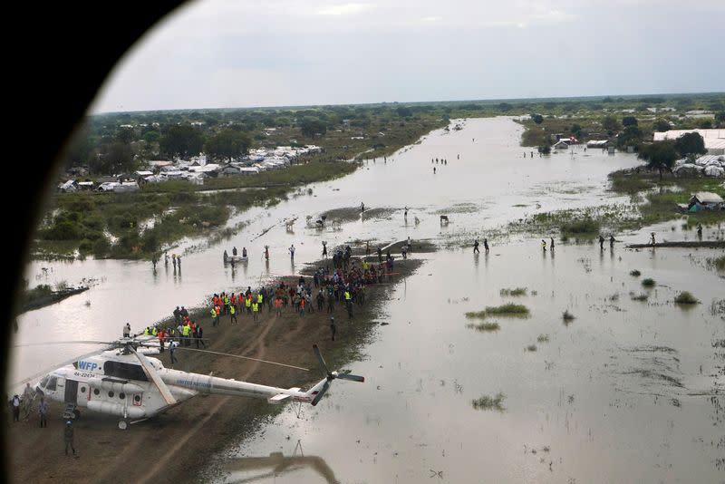 FILE PHOTO: A WFP helicopter is seen on the flooded airstrip, after heavy rains and floods forced hundreds of thousands of people to leave their homes, in the town of Pibor, Boma state