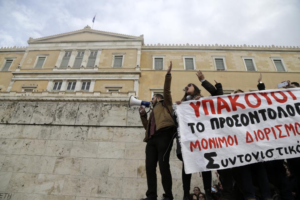 Protesters shout slogans outside the Greek Parliament during a protest in Athens, Friday, Jan. 11, 2019. About 1,500 people took part in the protest. Teachers' unions oppose the government's selection process for the planned hiring of 15,000 new teachers over the next three years. (AP Photo/Thanassis Stavrakis)