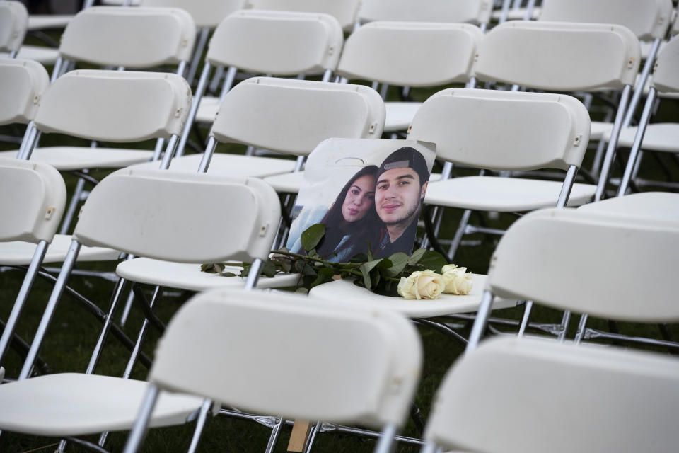 FILE- In this Sunday, March 8, 2020, file photo, A picture of Bryce Fredriksz and his girlfriend Daisy is placed amidst 298 empty chairs, each chair for one of the 298 victims of the downed Malaysia Air flight MH17, in a park opposite the Russian embassy in The Hague, Netherlands. The trial in absentia in a Dutch courtroom of three Russians and a Ukrainian charged in the downing of Malaysia Airlines flight MH17 in 2014 moves to the merits phase, when judges and lawyers begin assessing evidence. (AP Photo/Peter Dejong, File)