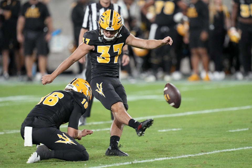 Arizona State place-kicker Dario Longhetto (37) boots an extra point against Washington State with the help of Arizona State holder Josh Carlson (16) during the first half of an NCAA college football game Saturday, Oct. 28, 2023, in Tempe, Ariz. (AP Photo/Ross D. Franklin)