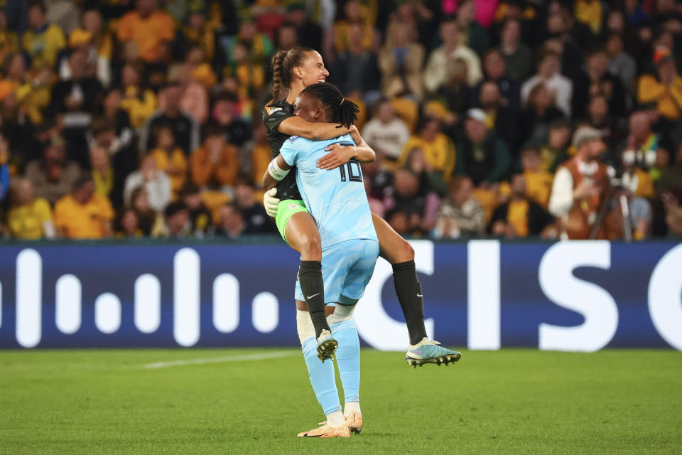 Nigeria's goalkeeper Chiamaka Nnadozie, right, celebrates with teammate Nigeria's Ashleigh Plumptre after teammate Asisat Oshoala scored their side's third goal during the Women's World Cup Group B soccer match between Australia and Nigeria In Brisbane, Australia, Thursday, July 27, 2023. (AP Photo/Tertius Pickard)