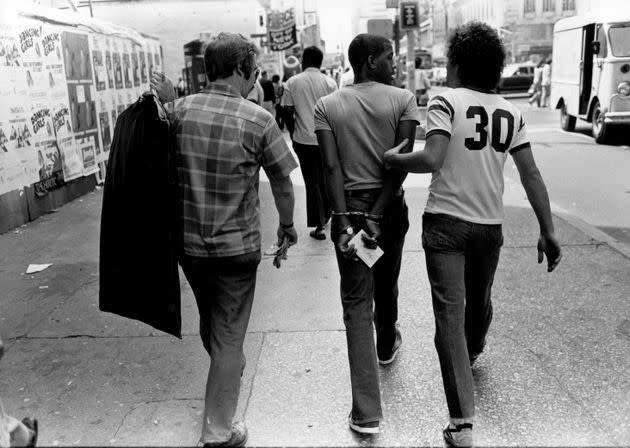 A Black man gets arrested on the street in 1980s New York.