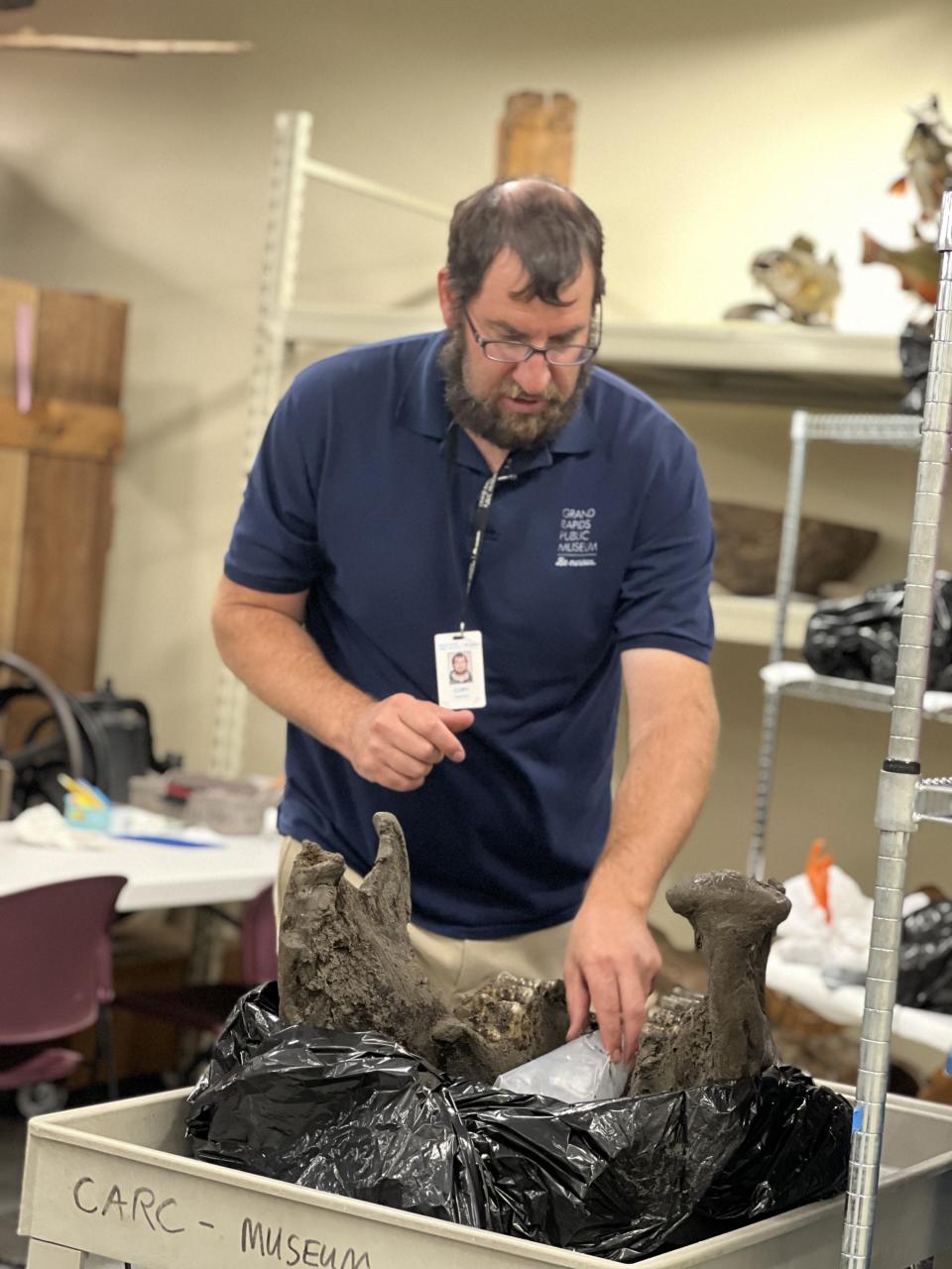 Grand Rapids Public Museum workers excavate mastodon bones from a Kent County field Aug. 12.