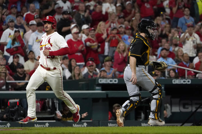 St. Louis Cardinals' Nolan Arenado, left, scores past Pittsburgh Pirates catcher Jason Delay during the second inning of a baseball game Saturday, Oct. 1, 2022, in St. Louis. (AP Photo/Jeff Roberson)