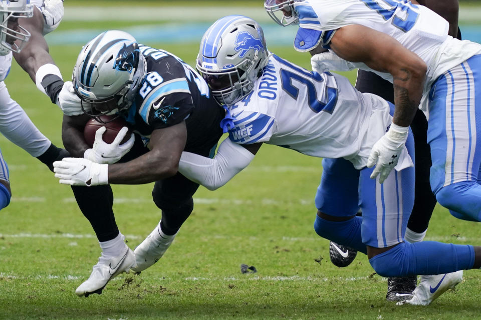 Carolina Panthers running back Mike Davis is tackled by Detroit Lions cornerback Amani Oruwariye during the second half of an NFL football game Sunday, Nov. 22, 2020, in Charlotte, N.C. (AP Photo/Gerry Broome)