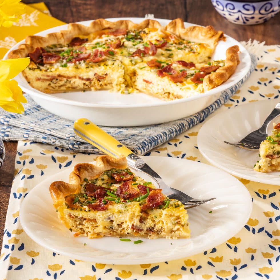 quiche lorraine slice on plate with fork