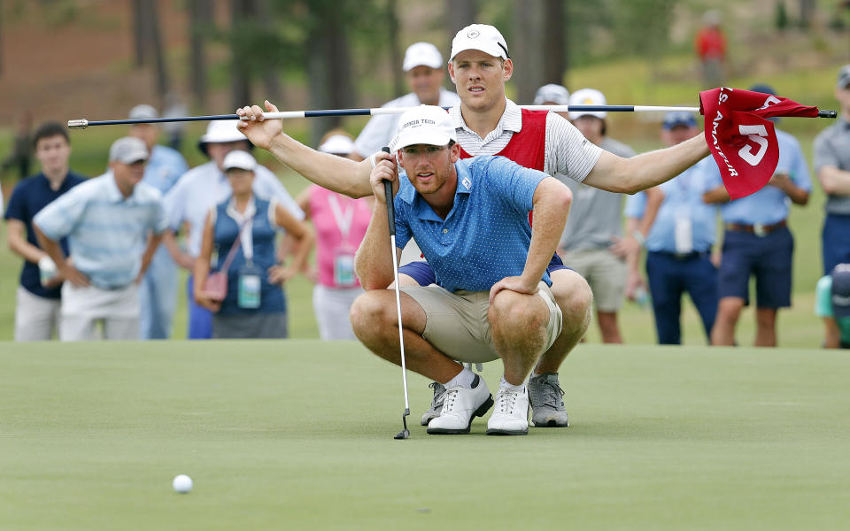 Andy Ogletree eyes his putt during the final round against John Augenstein at the USGA Amateur Golf Championship at the Pinehurst Country Club , in Pinehurst, N.C, Sunday, Aug. 18, 2019, (AP Photo/Karl B DeBlaker)