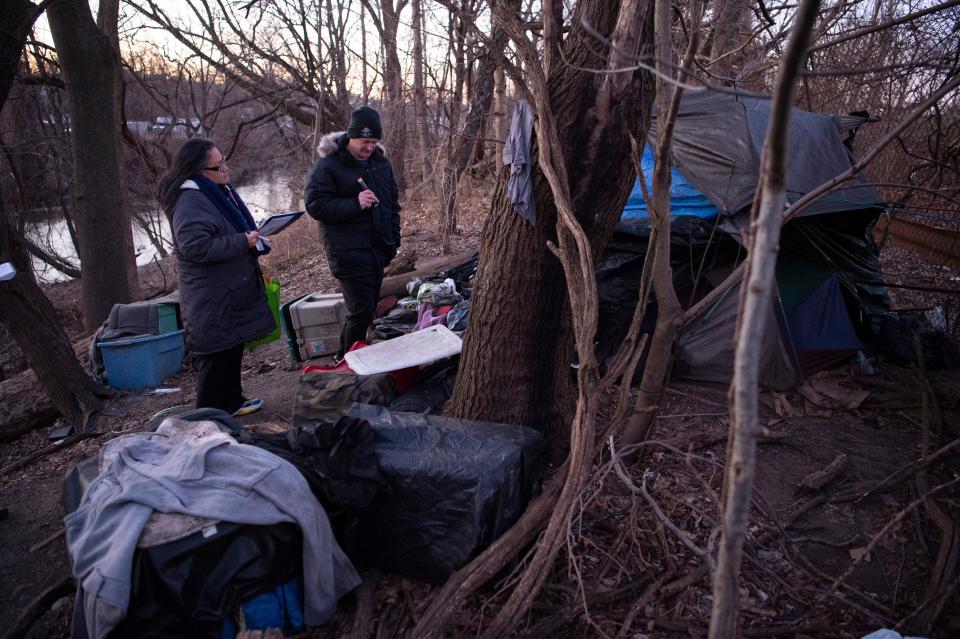 Shaun Hutchinson, right, and Yahaira Padilla, of Bergen County Veterans Services, talk with a homeless man who was sleeping in a wooded area in southwestern Bergen County on Wednesday Jan. 26, 2022. Bergen County Health and Human Services personnel travel throughout the county to find and document homeless individuals during the Point-in-Time homeless count. 