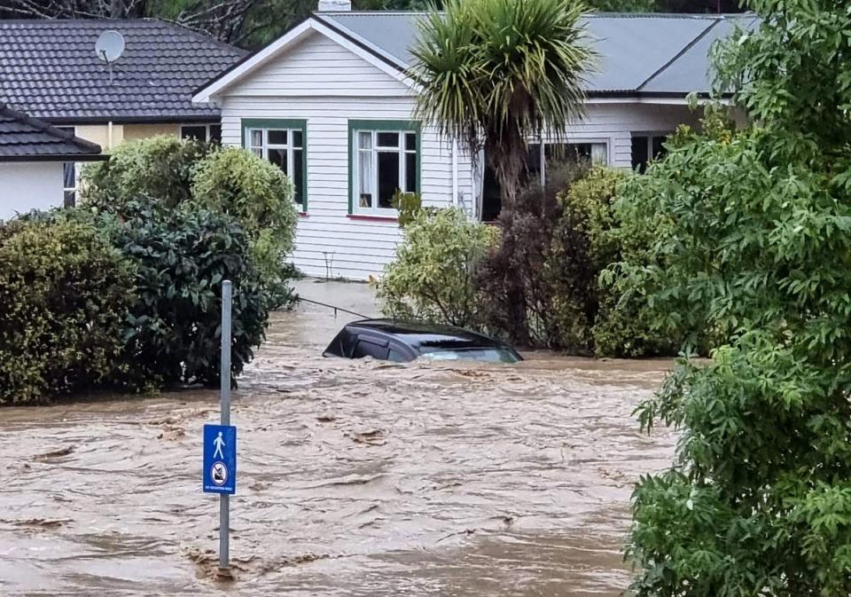 A flood-inundated car and homes from the overflowing Maitai river in central Nelson (Andrew App/AFP via Getty)