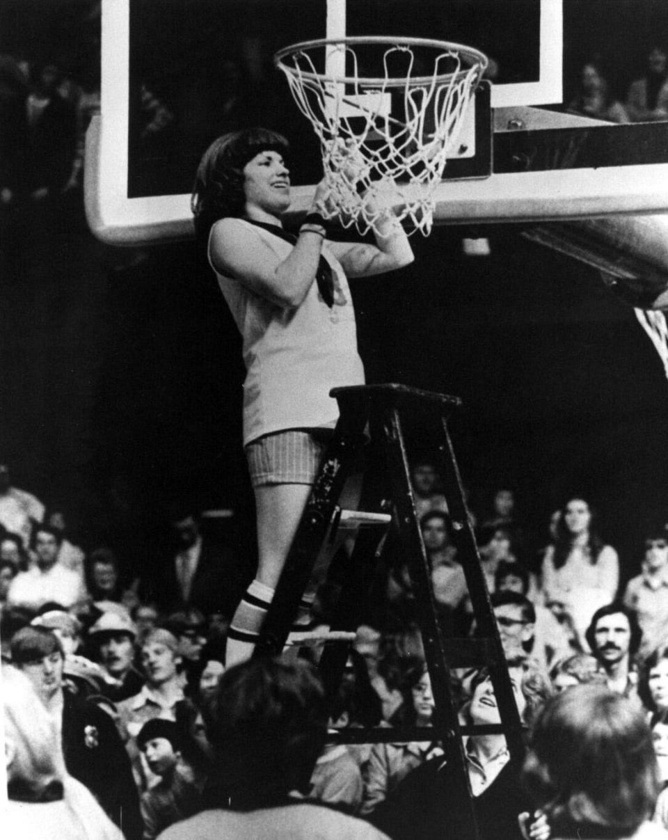 Warsaw's Judi Warren cuts down her portion of the net after the Tigers won their first girls basketball state championship on Feb. 28, 1976, at Hinkle Fieldhouse.