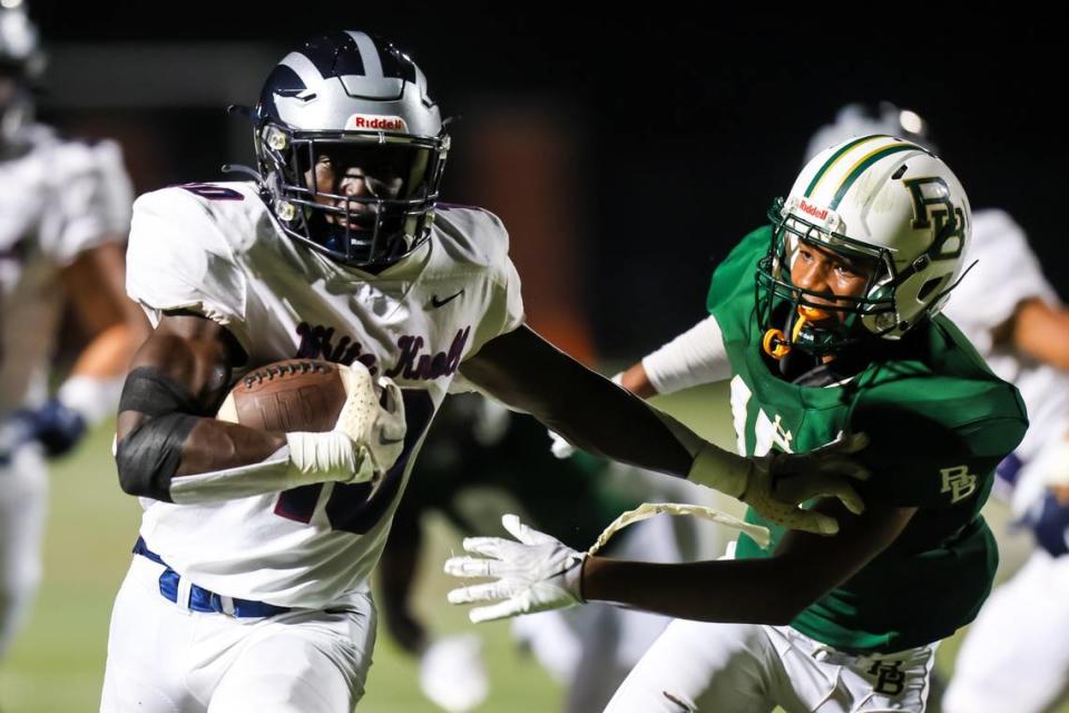 White Knoll Timberwolves linebacker Jaiden Kimble (10) stiff-arms River Bluff Gators Elijah Hayes (15) on the way to a touchdown during their game at River Bluff High School Friday night, Sept. 29, 2023.