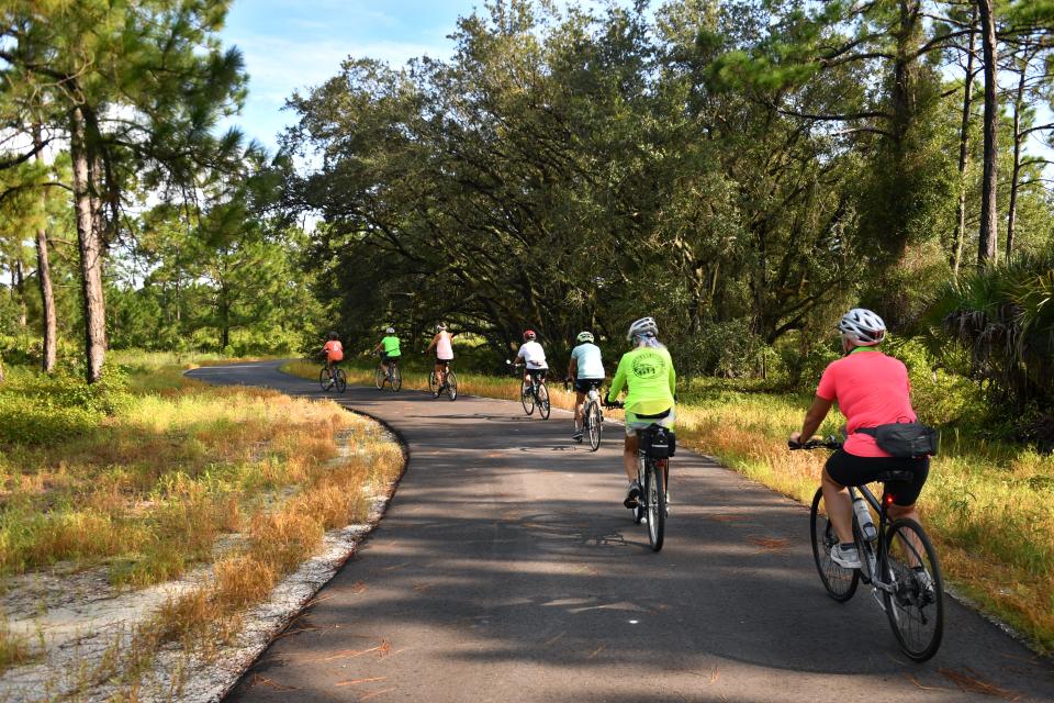 A group of cyclists head north on the Legacy Trail, along the Schewe Tract near North Port.  Sarasota County officially opened the North Port Connector segment of the Legacy Trail on Friday, Sept. 9, 2022.