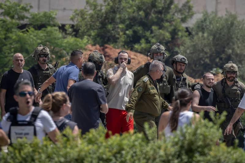 Shlomi Ziv (L), 40, Andrey Kozlov (C), 27, and Almog Meir, 21, three of the four Israeli hostages who were kidnapped by Hamas from the Nova music festival on 7 October, arrive by a helicopter at the Sheba Medical center in Ramat Gan. The Israel Defense Forces (IDF) said on Saturday that it had rescued four Israeli hostages in a "complex special daytime operation" in Nuseirat, a refugee camp in the central Gaza Strip. Ilia Yefimovich/dpa