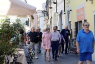 Britain's Prime Minister Theresa May walks with her husband Philip in Desenzano del Garda, by Lake Garda, northern Italy, July 25, 2017. REUTERS/Antonio Calanni/Pool