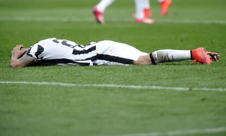 Juventus' Arturo Vidal reacts as he lies on the pitch during their Italian Serie A soccer match against Torino at Olympic Stadium in Turin April 26, 2015. REUTERS/Giorgio Perottino