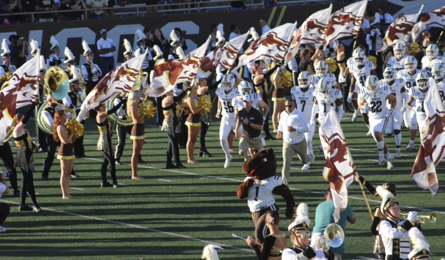 Western Michigan University head football coach Lance Taylor (Choctaw) leads his team out of the tunnel for the season opener on Thursday night. (Photos/Levi Rickert)