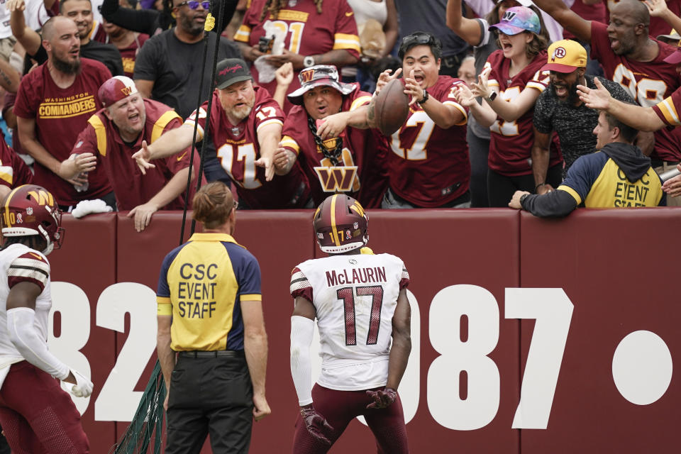 Washington Commanders wide receiver Terry McLaurin (17) tosses the football to fans after scoring a touchdown against the Jacksonville Jaguars during the second half of an NFL football game, Sunday, Sept. 11, 2022, in Landover, Md. (AP Photo/Alex Brandon)