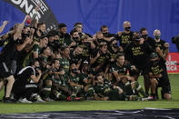 Portland Timbers players pose for photos after defeating Orlando City 2-1, during an MLS soccer tournament, Tuesday, Aug. 11, 2020, in Kissimmee, Fla. (AP Photo/John Raoux)