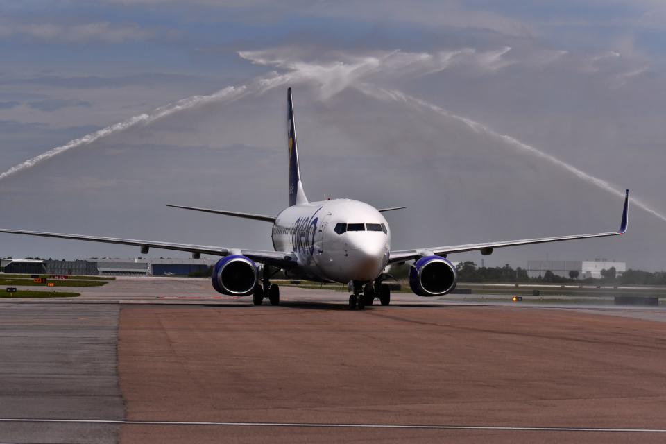 The first Avelo Airlines jet from New Haven, Connecticut, receives a fire-truck water cannon salute after landing on June 21 at Melbourne Orlando International Airport.