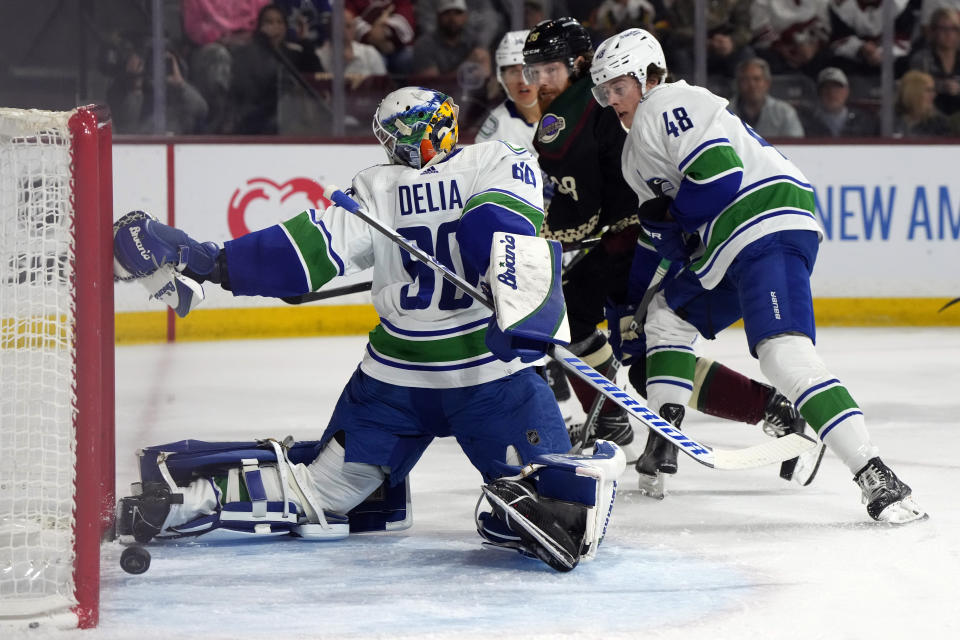 Arizona Coyotes center Liam O'Brien (38) scores against Vancouver Canucks goaltender Collin Delia during the first period of an NHL hockey game Thursday, April 13, 2023, in Tempe, Ariz. (AP Photo/Rick Scuteri)