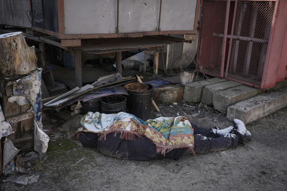 The body of Dmytro Chaplyhin, called Dima, lies on the ground after it was identified by a neighbor after he was killed on the grounds of 144 Yablunska Street, an industrial complex Russian troops used as a headquarters in Bucha, Ukraine, Monday, April 4, 2022. Russian soldiers found images of Russian tanks on Dima's phone and accused him of being a spotter helping the Ukrainian military. Ukrainian prosecutors now say those responsible for the violence at 144 Yablunska were soldiers from the 76th Guards Airborne Assault Division, under the ultimate battlefield command of Alexander Chaiko, a colonel general known for his brutality as leader of Russia's troops in Syria. (AP Photo/Vadim Ghirda)