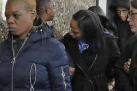 Katima Minton, center, mother of Rashaun Weaver, who has been charged in the December fatal stabbing of 18-year-old Barnard College student Tessa Majors, leaves court in New York after his court appearance, Wednesday, Feb. 19, 2020. (AP Photo/Richard Drew)