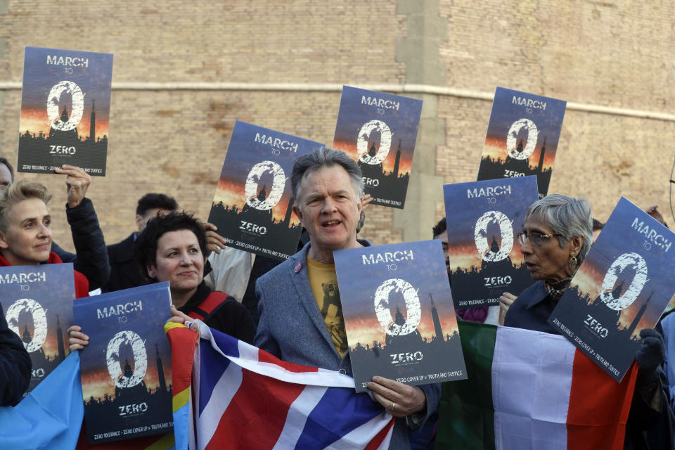 People gather during a vigil prayer of the victims of sex abuse near Castle Sant' Angelo in Rome, Thursday, Feb. 21, 2019. The gathering of church leaders from around the globe is taking place amid intense scrutiny of the Catholic Church's record after new allegations of abuse and cover-up last year sparked a credibility crisis for the hierarchy. (AP Photo/Gregorio Borgia)