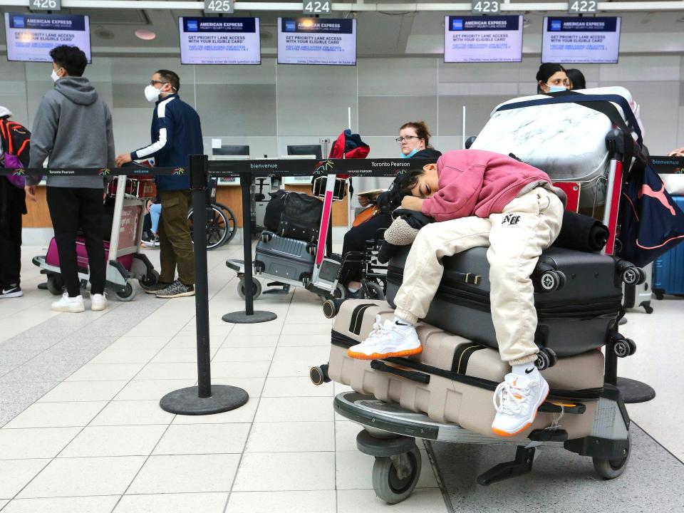 A child sleeps as his family waits for their flight to Mexico at Toronto Pearson International Airport in April 2022.