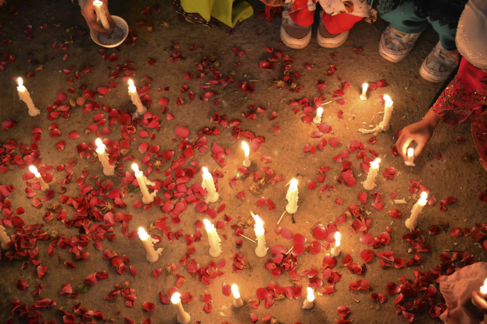 Pakistani children, hold candles during a vigil to condemn the attacks on their ethnic Hazara community, in Quetta, Pakistan, Sunday, Feb. 16, 2014. (AP Photo/Arshad Butt)