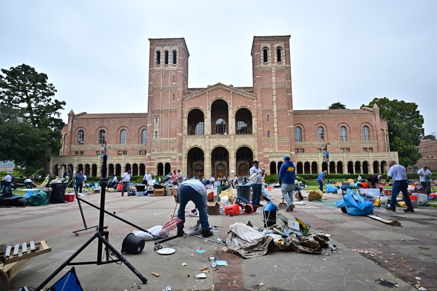 Workers clean up the University of California, Los Angeles (UCLA) campus after police evicted pro-Palestinian students, in Los Angeles, California, early on May 2, 2024. Hundreds of police tore down protest barricades and began arresting students early Thursday at the University of California, Los Angeles – the latest flashpoint in an eruption of protest on US campuses over Israel’s war against Hamas in Gaza. (Photo by Frederic J. Brown / AFP) (Photo by FREDERIC J. BROWN/AFP via Getty Images)