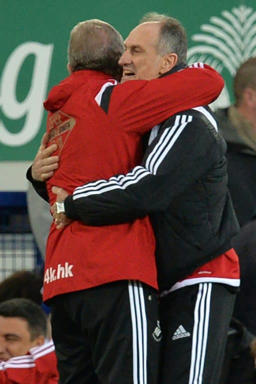 Swansea City's head coach Francesco Guidolin (R) celebrates with Swansea City's first team coach Alan Curtis at the final whistle in the English Premier League football match between Everton and Swansea City in Liverpool, England on January 24, 2016