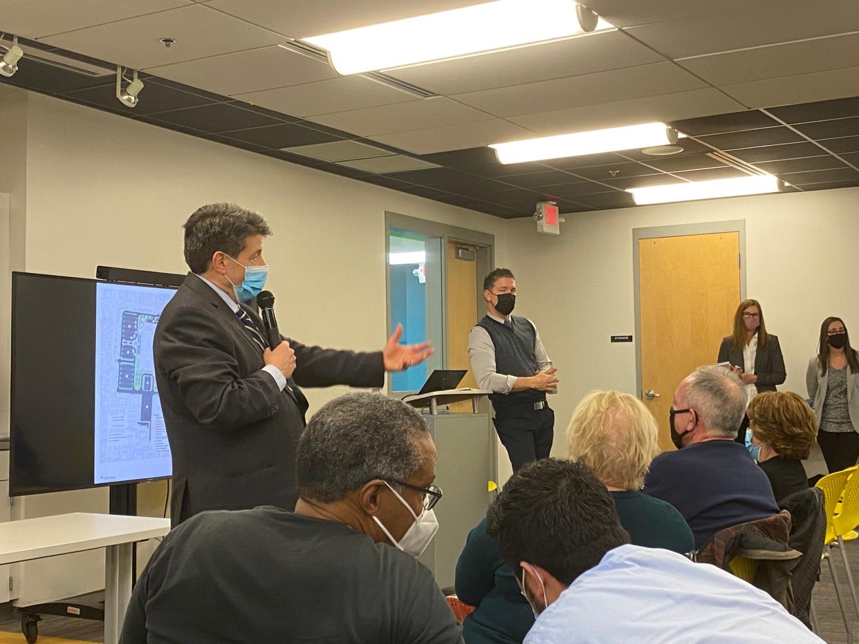 Gahanna-Jefferson Public Schools Superintendent Steve Barrett and Paul Lawton, architect with DLR Group, describe high school site-plan options with neighbors during a  Jan. 12 meeting at Clark Hall.