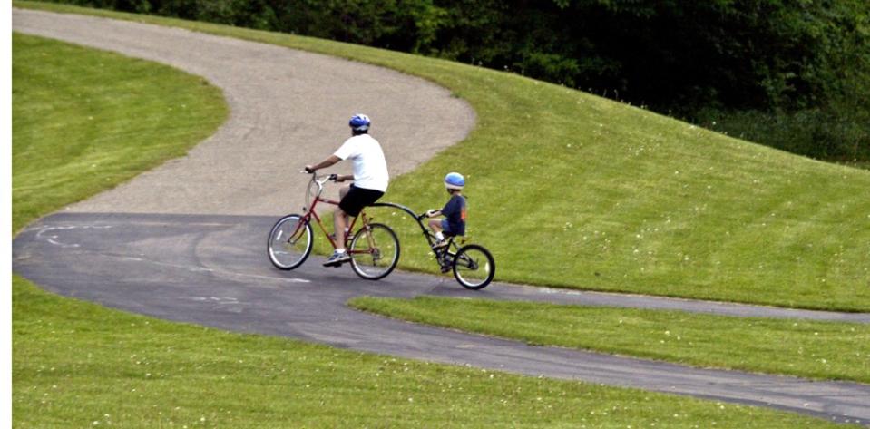 A biker and one-half on a bike and one-half make it up a path in Phalen-Keller Regional Park in St. Paul via Getty Images