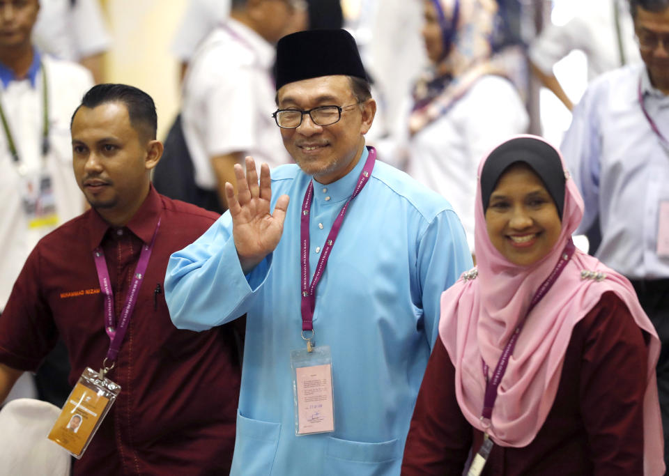 Malaysia's reform icon Anwar Ibrahim, center, thumbs up as he arrives for by-election nomination in Port Dickson, Malaysia, Saturday, Sept. 29, 2018. Anwar is contesting by-election in Port Dickson, a southern coastal town after a lawmaker vacated the seat to make way for Anwar Ibrahim's political comeback. (AP Photo/Vincent Thian)