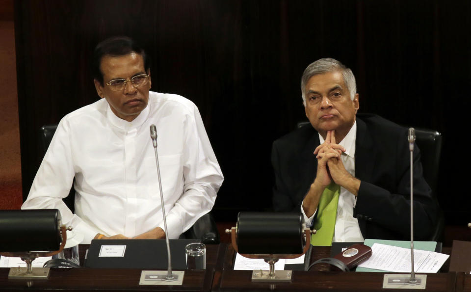 FILE- In this Oct. 3, 2017, file photo, Sri Lankan President Maithripala Sirisena, left, and Prime Minister Ranil Wickremesinghe attend a special session held to mark the country's seventieth anniversary of the first parliament of democracy, in Colombo, Sri Lanka. (AP Photo/Eranga Jayawardena, File)