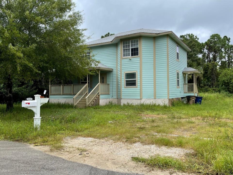 A  Lehigh Acres home listed as the residence of a couple named in a federal fraud indictment Thursday appeared abandoned and neglected. A lockbox was affixed to the front door.