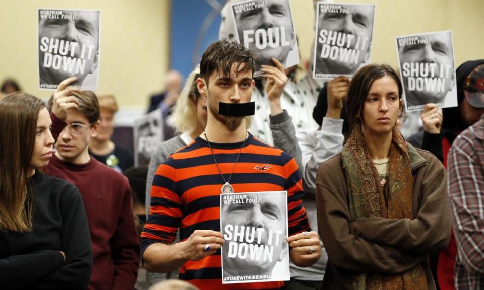 Protesters turn their backs on a meeting of the Virginia state air quality control board in Richmond, Virginia, in January 2019.