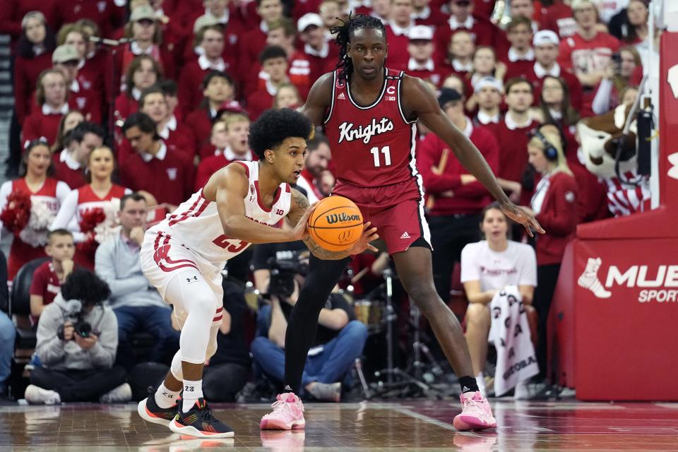 Feb 18, 2023; Madison, Wisconsin, USA;  Wisconsin Badgers guard Chucky Hepburn (23) passes against Rutgers Scarlet Knights center Clifford Omoruyi (11) during the first half at the Kohl Center. Mandatory Credit: Kayla Wolf-USA TODAY Sports