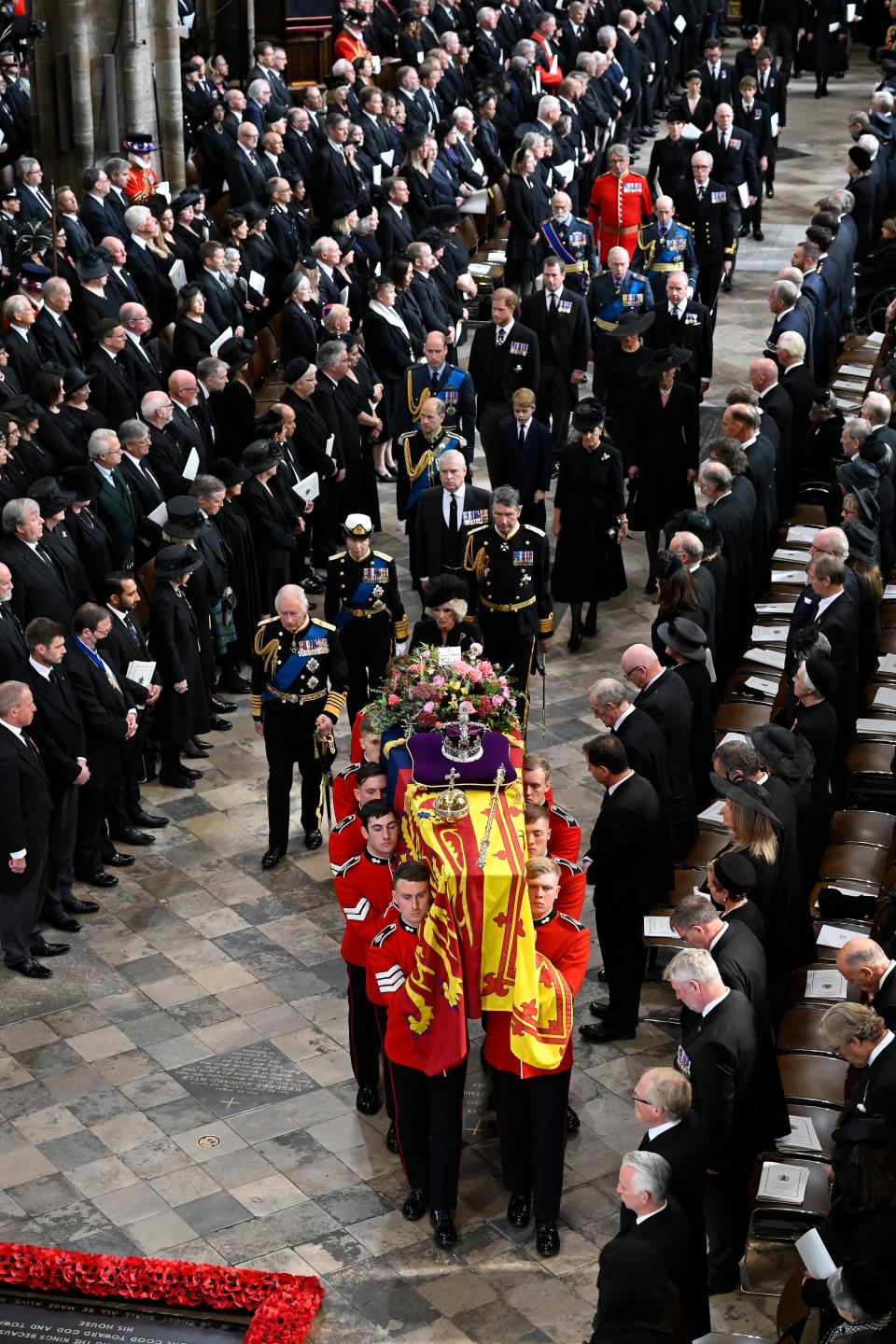 The royal family  walk alongside the coffin carrying Queen Elizabeth II as it departs Westminster Abbey.